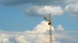 A lone tower crane in a beautiful cloudy sky. time lapse
