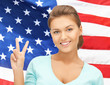 Foto: young woman showing victory or peace sign young woman showing victory or peace sign
