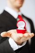 man with wedding ring and gift box