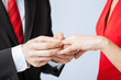 man putting  wedding ring on woman hand