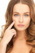 woman pointing at her cheek