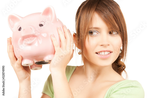 Photo: lovely girl with big piggy bank lovely girl with big piggy bank