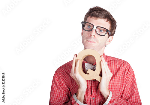 Photo: Businessman holding Q for question Businessman holding Q for question