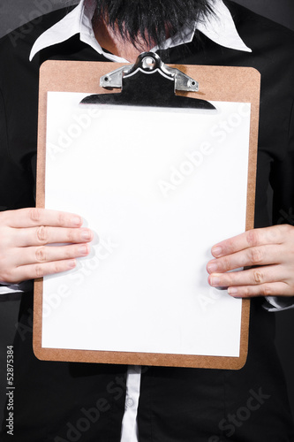 Photo: Businessman conducting survey with blank clipboard Businessman conducting survey with blank clipboard