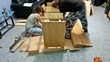 Man and woman doing assembly furniture, timelapse