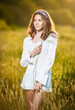 Photo: Vintage looking pose of a Young woman standing in a wheat field Vintage looking pose of a Young woman standing in a wheat field