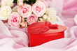 Beautiful gift on flowers background