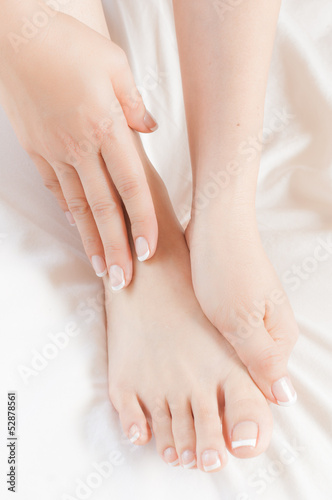 Photo: Woman gently massages her own pedicured foot Woman gently massages her own pedicured foot