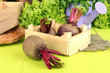 Young beets on wooden box on wooden table close-up