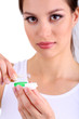 Young woman putting contact lens in her eye close up