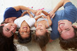 Family Lying Upside Down On Bed In Pajamas Together