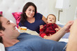 Photo: Family Relaxing In Bed With Coffee And Newspaper Family Relaxing In Bed With Coffee And Newspaper
