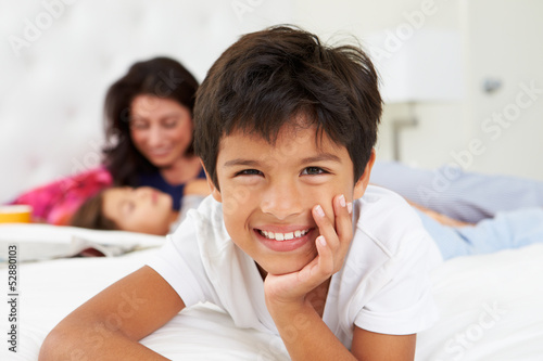 Photo: Mother And Children Relaxing In Bed Wearing Pajamas Mother And Children Relaxing In Bed Wearing Pajamas