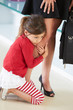 Daughter Clinging To Working Mother's Leg
