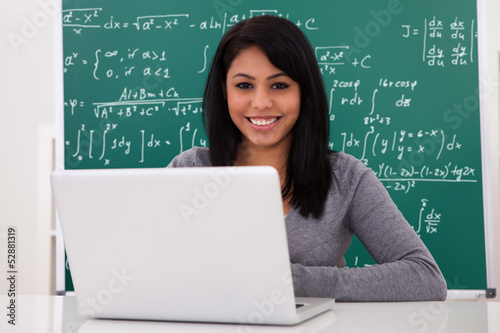 Photo: Portrait Of Female Student Using Laptop Portrait Of Female Student Using Laptop