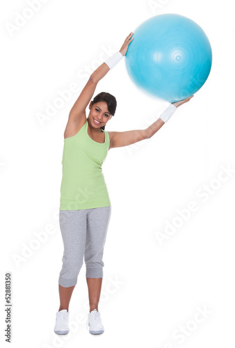Photo: Young Woman Exercising With Pilates Ball Young Woman Exercising With Pilates Ball