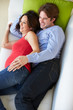 Photo: Overhead View Of Man And Pregnant Wife Watching TV On Sofa Overhead View Of Man And Pregnant Wife Watching TV On Sofa