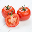 Photo: Close-up of two red ripe tomatoes and their segment Close-up of two red ripe tomatoes and their segment