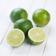 Fruits: fresh ripe limes on wooden boards, studio shot