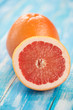 Vertical shot of ripe grapefruit and its half, close-up