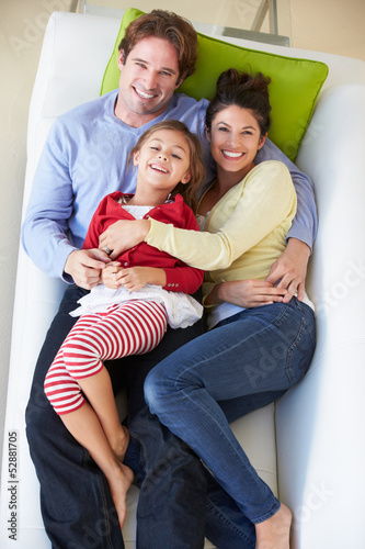 Photo: Overhead View Of Family Relaxing On Sofa Overhead View Of Family Relaxing On Sofa