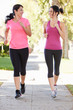 Photo: Two Female Runners Exercising On Suburban Street Two Female Runners Exercising On Suburban Street