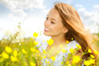 Beauty Girl in the Meadow lying on Green Grass with wild Flowers