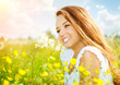 Beauty Girl in the Meadow lying on Green Grass