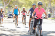Photo: Group Of Cyclists On Suburban Street Group Of Cyclists On Suburban Street