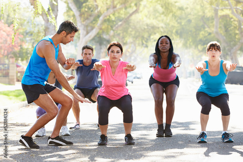 Photo: Group Of People Exercising Street With Personal Trainer Group Of People Exercising Street With Personal Trainer