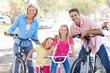 Family Cycling On Suburban Street