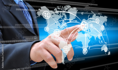 Photo: hand pushing social network button on a touch screen interface hand pushing social network button on a touch screen interface