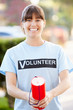 Portrait Of Charity Volunteer On Street With Collection Tin