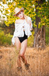 sexy portrait woman with hat and white shirt in the autumn park