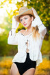 sexy portrait woman with hat and white shirt in the autumn park