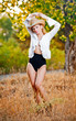 sexy portrait woman with hat and white shirt in the autumn park