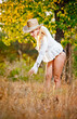 sexy portrait woman with hat and white shirt in the autumn park