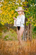 sexy portrait woman with hat and white shirt in the autumn park