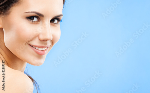 Photo: Portrait of beautiful woman, on blue Portrait of beautiful woman, on blue