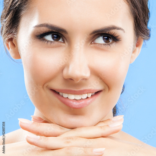 Photo: Portrait of beautiful woman, on blue Portrait of beautiful woman, on blue