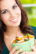 Photo: Young woman with salad, outdoors Young woman with salad, outdoors