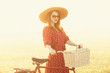 Girl on a bike in the countryside in sunrise time.