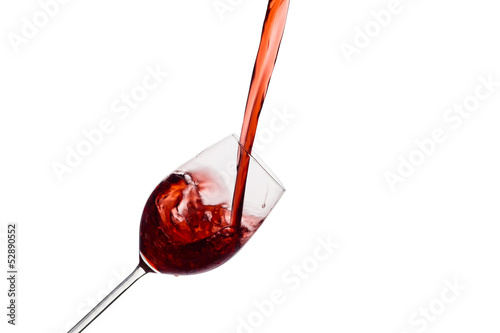 Photo: Rotwein wird in ein Weinglas eingegossen Rotwein wird in ein Weinglas eingegossen