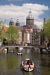 Foto: City of Amsterdam with boat on canal in Holland City of Amsterdam with boat on canal in Holland