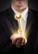 Male hand holding a golden key