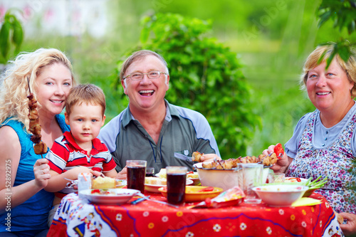 Photo: happy family together in picnic, colorful outdoors happy family together in picnic, colorful outdoors