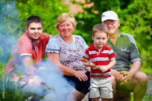 Photo: happy family portrait on picnic, colorful outdoors happy family portrait on picnic, colorful outdoors