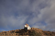 Happy newlyweds sitting on volcanic  hill.