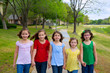 Children group of sisters girls and friends walking in park