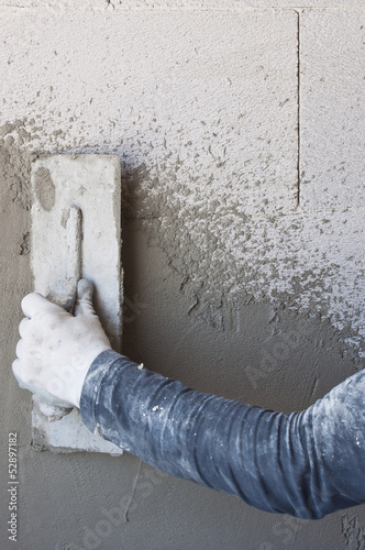 Photo: Construction site - Worker performs internal plaster Construction site - Worker performs internal plaster